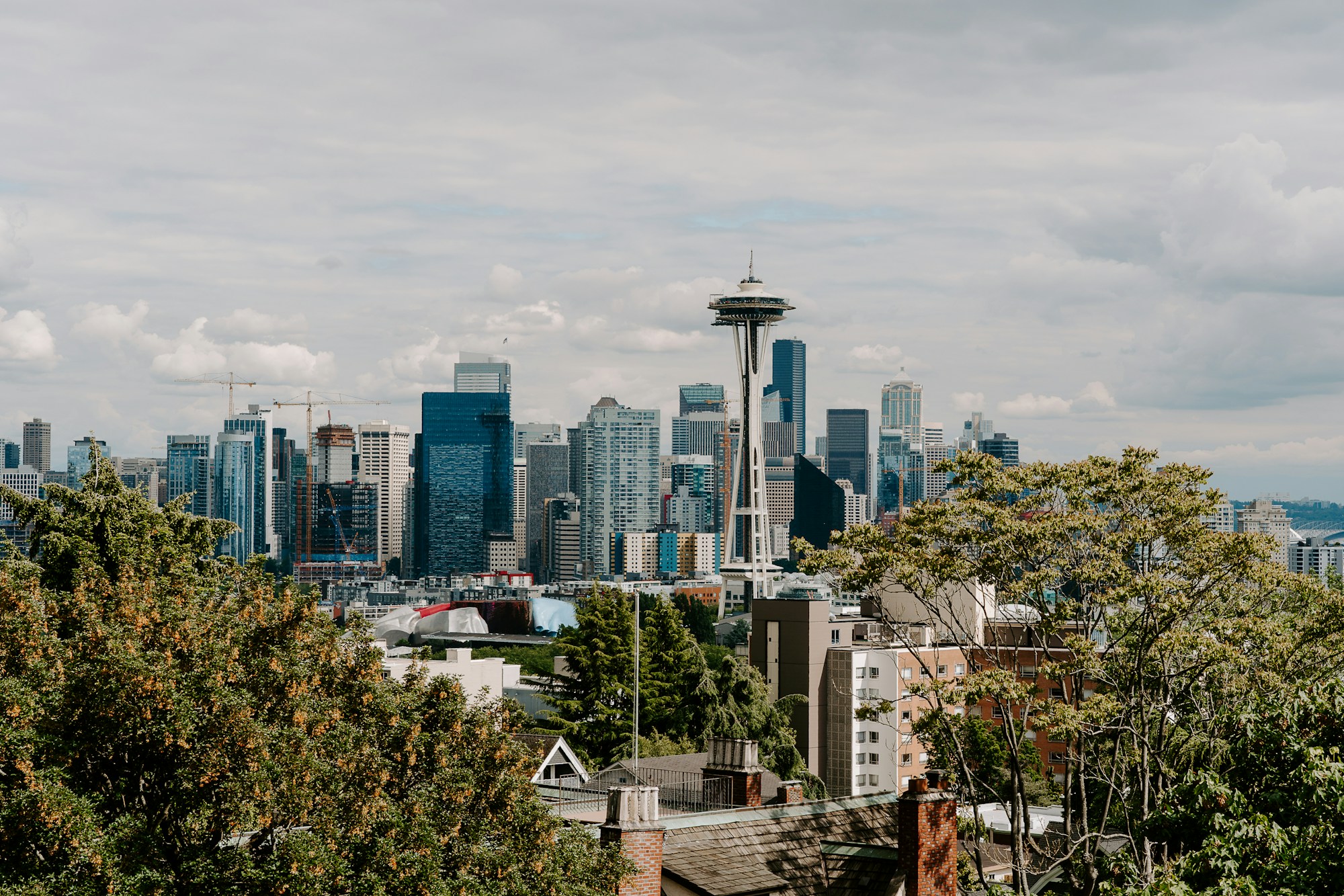 Seattle skyline and Space Needle above surrounding neighborhoods